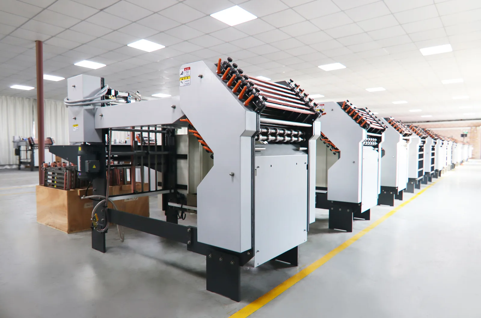 A row of folding machines on the SPEED production floor